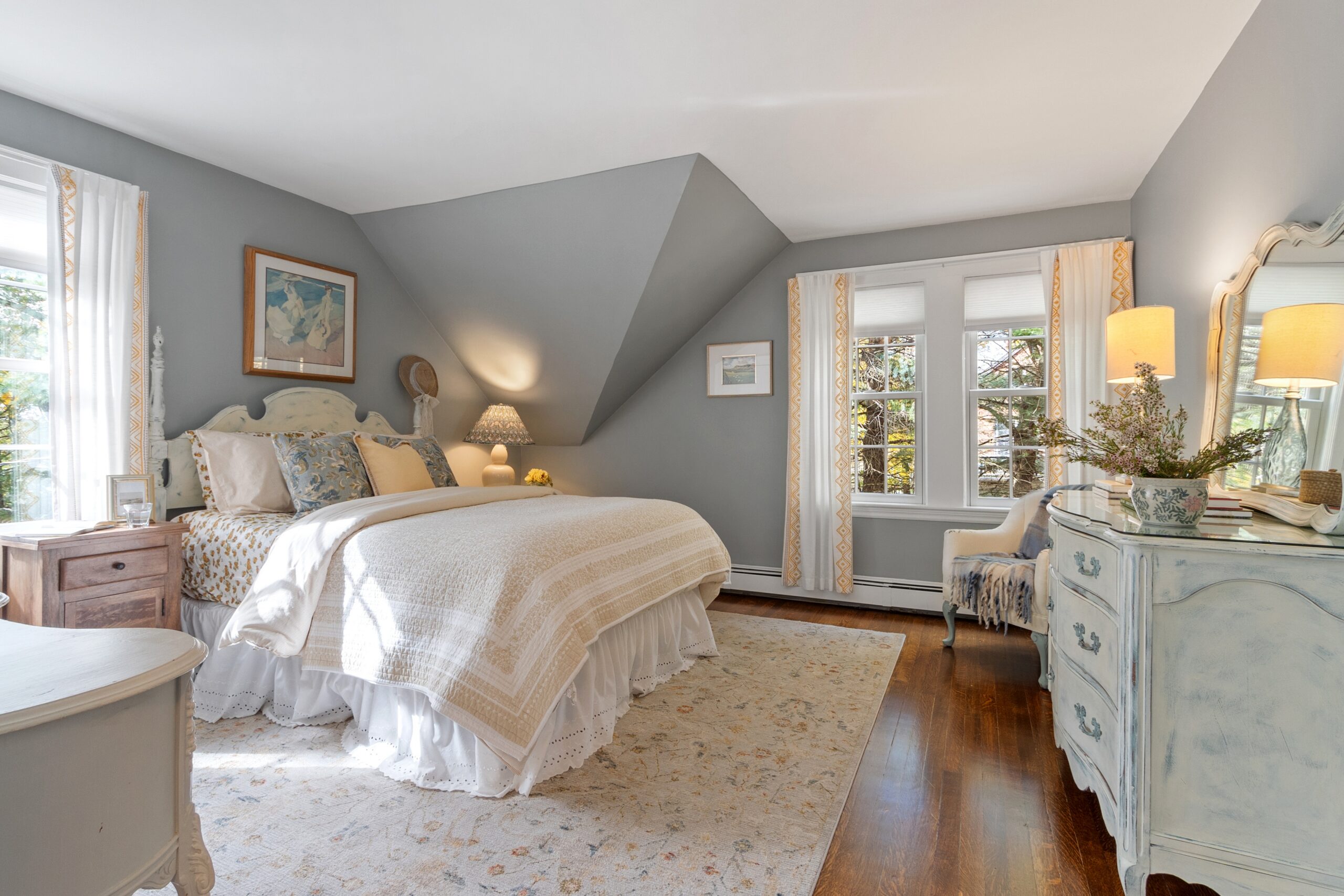 Renovated bedroom with vaulted ceiling and antique furniture in Medford, MA