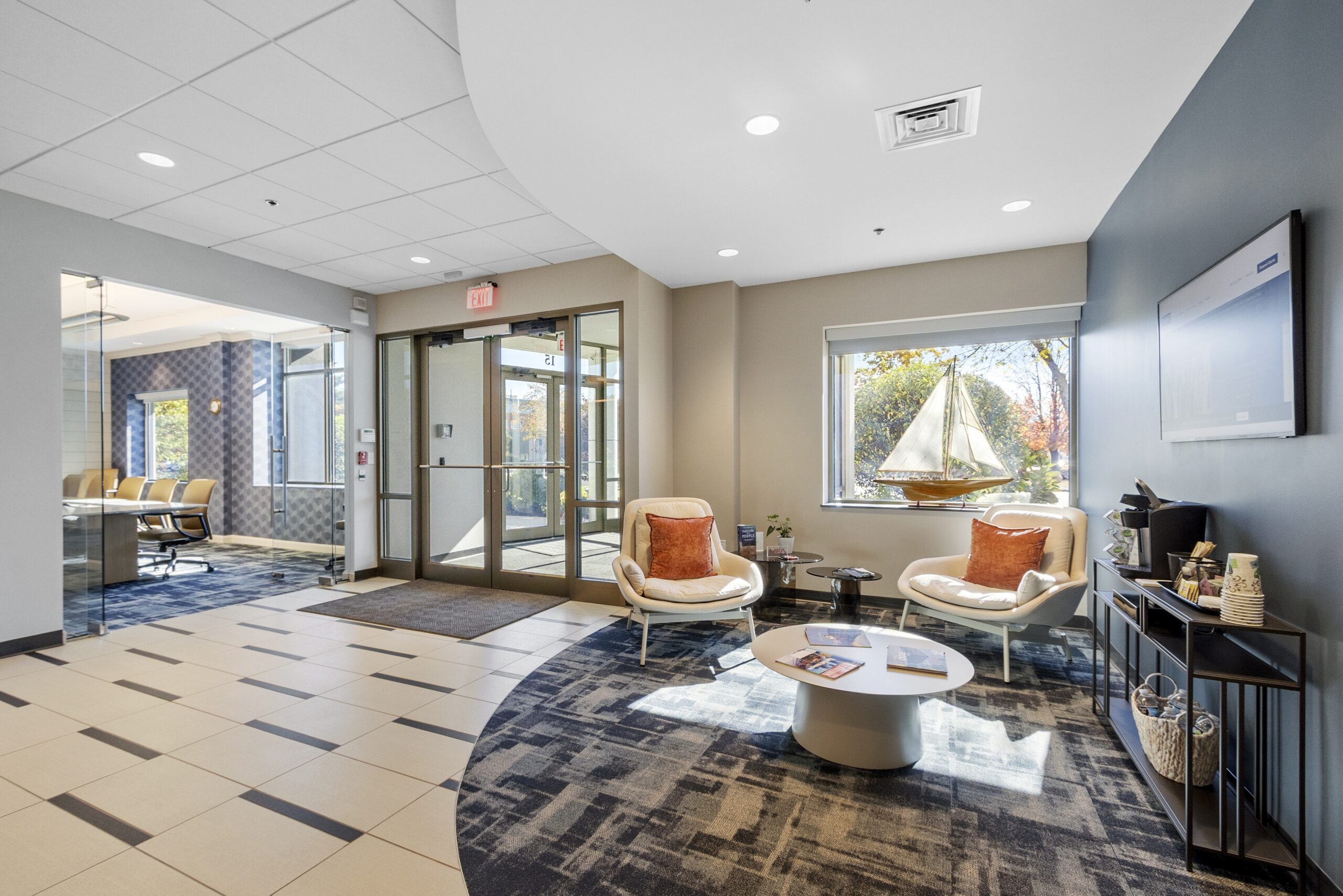 Renovated office lobby with waiting area and glass entry doors in Woburn, MA